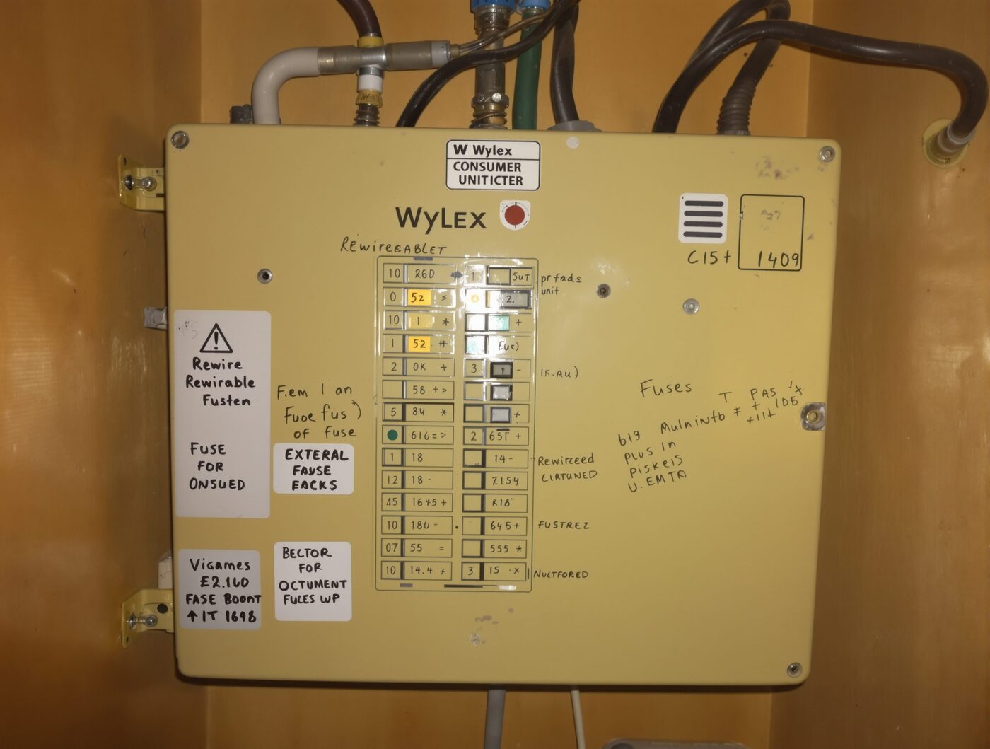 Old UK consumer unit, dated plastic case, loose wires